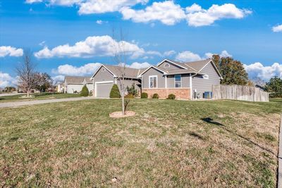 Ranch-style home featuring a garage and a front lawn | Image 3