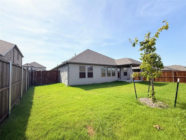 Rear view of property with a fenced backyard and a shingled roof | Image 34