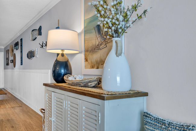 Detailed view of wood finished floors, a wainscoted wall, and crown molding | Image 10