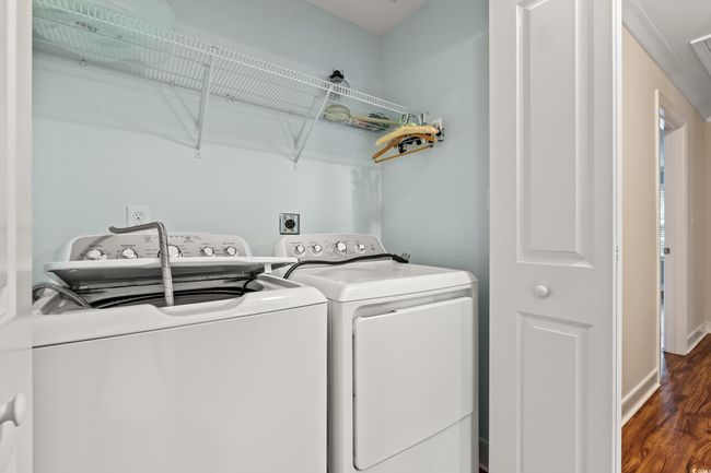 Washroom featuring independent washer and dryer and wood finished floors | Image 19