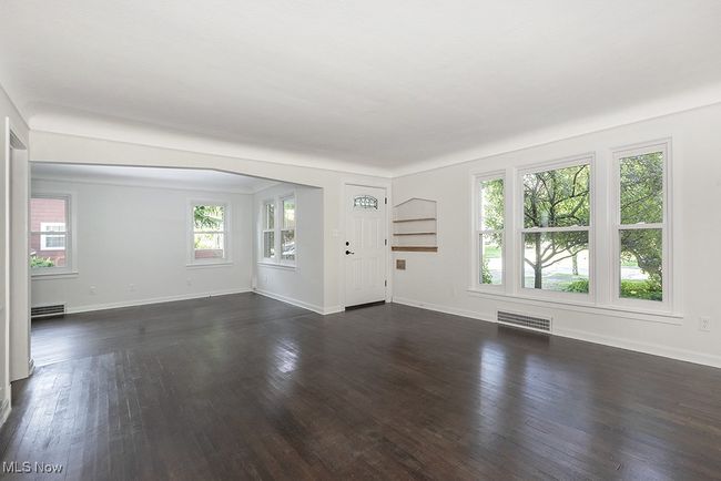 Unfurnished living room featuring dark wood-type flooring | Image 7