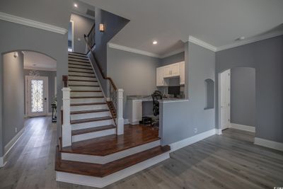 Stairway featuring hardwood / wood-style floors and ornamental molding | Image 2