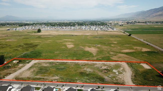 Aerial view of property and surrounding area featuring a mountainous background and property boundaries highlighted | Image 6