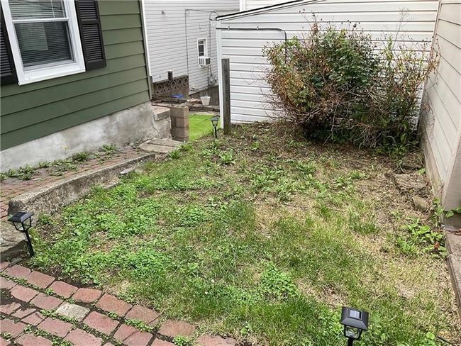 Lots of potential for this yard! Pave the whole thing for easy entertaining | Image 22