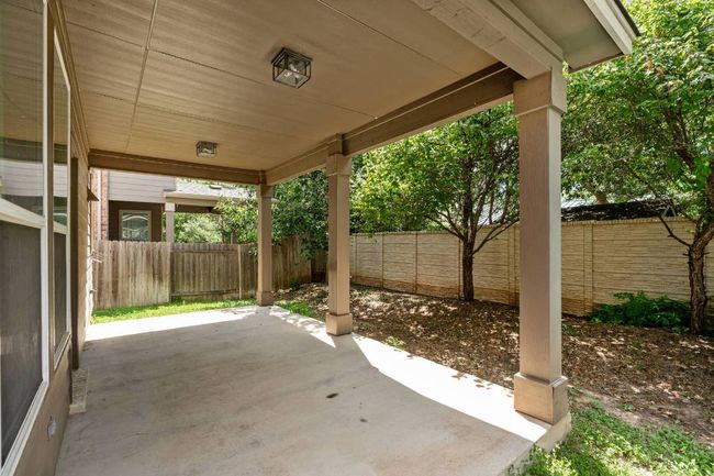 Fenced backyard with a patio area | Image 16