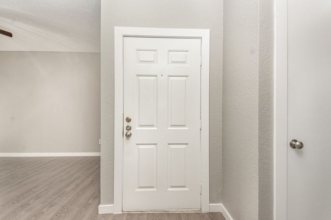Doorway to outside with wood finished floors and baseboards | Image 4