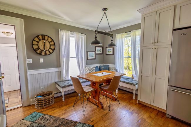 Dining area with wainscoting, light wood-type flooring, and ornamental molding | Image 15