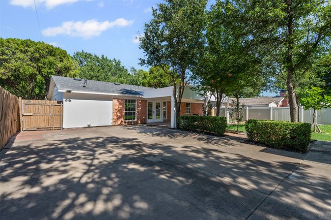 View of front of house with french doors, a gate, and concrete driveway | Image 30
