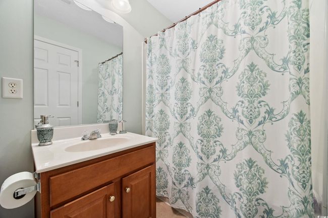 Bathroom with vanity and a shower with curtain | Image 36