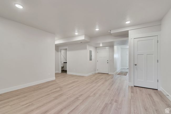 Finished basement with electric panel, light wood finished floors, and recessed lighting | Image 24
