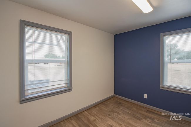 Empty room with wood finished floors and baseboards | Image 9