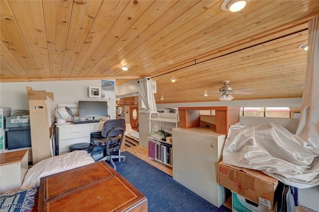 Carpeted office with wooden ceiling and ceiling fan | Image 37