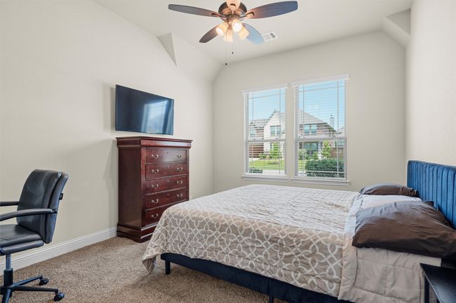 Bedroom with carpet floors, a ceiling fan, and lofted ceiling | Image 12