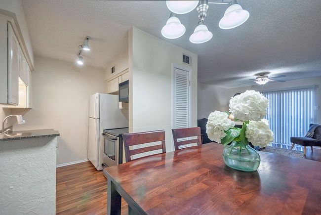 The dining area, illuminated by a chandelier, is perfect for intimate meals. | Image 12