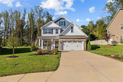 Front Elevation with covered front porch, wide driveway allowing for side by side parking, cul de sac lot, great side yard | Image 2