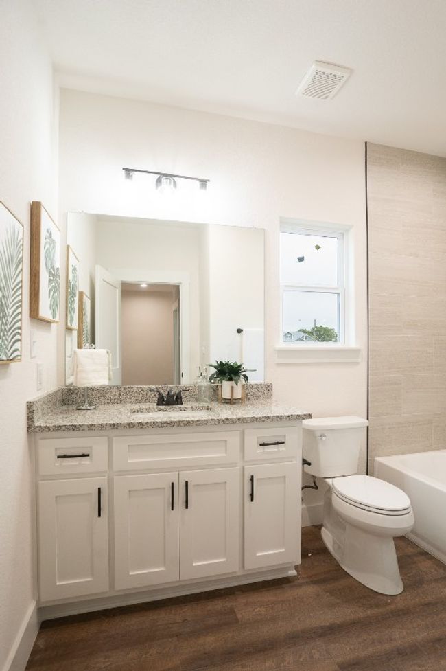 Bathroom featuring vanity, toilet, wood finished floors, and baseboards | Image 25