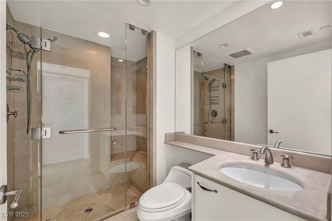 Full bath featuring visible vents, toilet, a stall shower, and vanity | Image 28