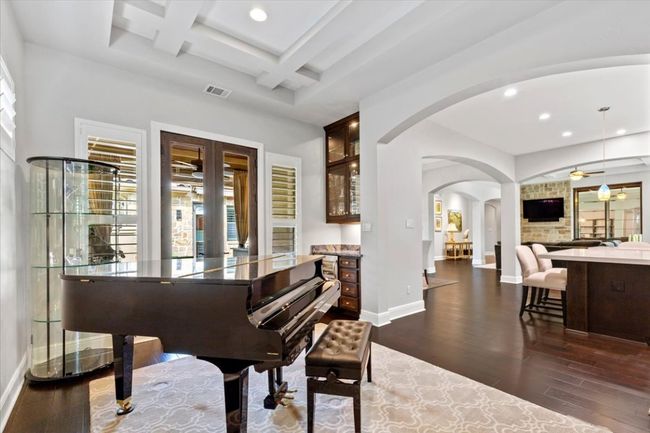 Living area featuring dark wood finished floors, arched walkways, baseboards, and recessed lighting | Image 15