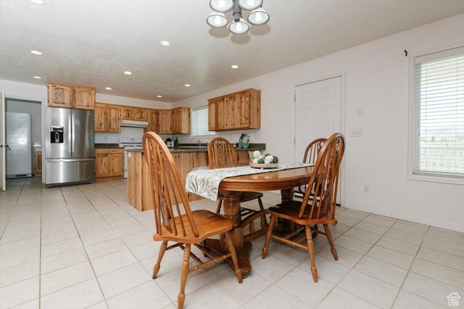 Dining space with recessed lighting, a chandelier, and light tile patterned flooring | Image 34