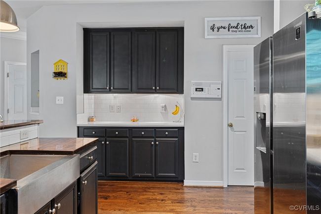 Kitchen featuring tasteful backsplash, dark cabinets, and dark wood-type flooring | Image 7