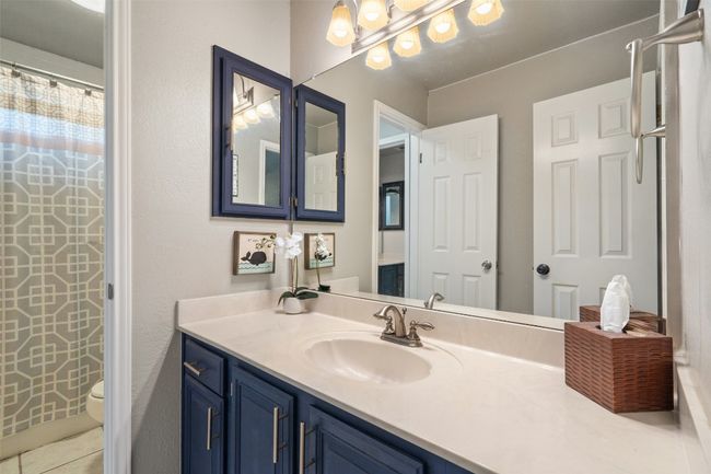 Bathroom featuring toilet and vanity | Image 28