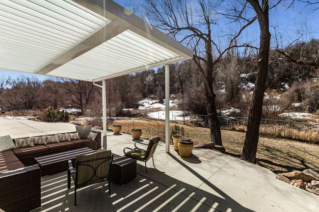Snow covered patio featuring fence and outdoor lounge area | Image 33