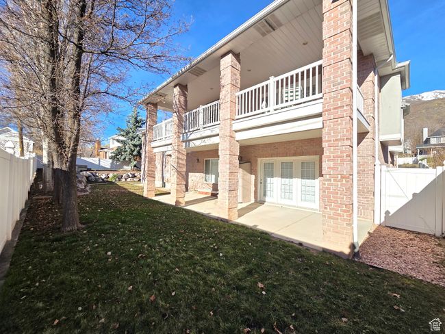 Rear view of property with a covered deck and covered patio. | Image 38