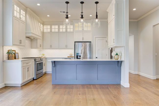 Large kitchen with plenty of cabinetry that reaches the ceiling. | Image 7