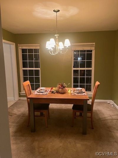 Dining room featuring an inviting chandelier and carpet | Image 3