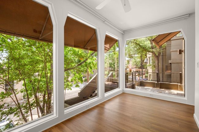 Floor to ceiling windows line the front wall, with views of the green tree tops in summer and the capital building in the winter. | Image 9
