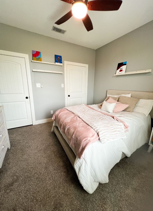 Bedroom featuring ceiling fan and carpet | Image 8