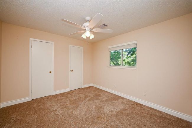 The 3rd secondary bedroom overlooks the backyard. | Image 24