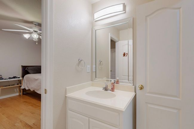 Bathroom with a ceiling fan, wood finished floors, and vanity | Image 23