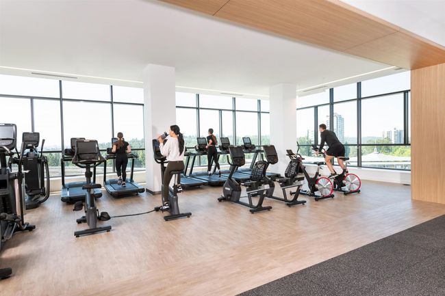 Exercise room featuring expansive windows and wood finished floors | Image 9