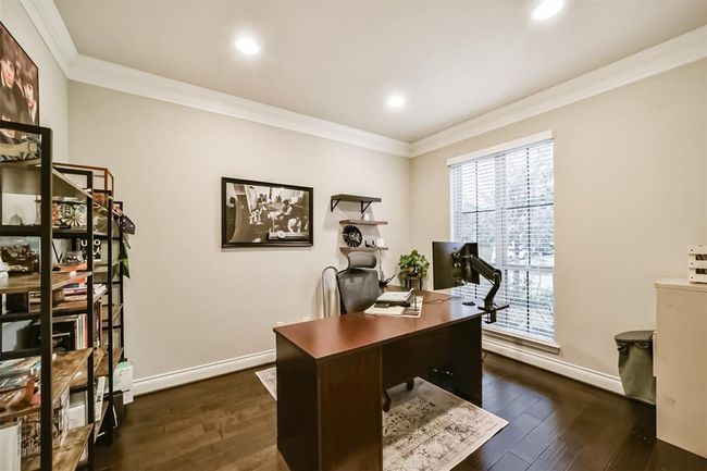 Overlooking the front yard, you'll enjoy a spacious home office with dual French doors for privacy. | Image 7