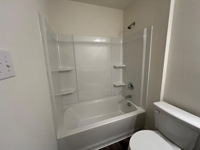 Bathroom with toilet and bathtub / shower combination | Image 28