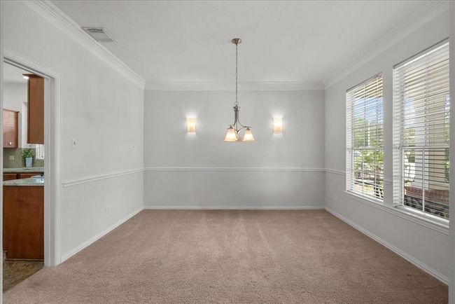 Do you enjoy entertaining? This formal dinning room is situated just off the kitchen for ease in moving between spaces. | Image 13