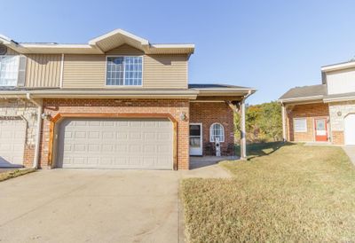 View of front of home featuring a front yard and a garage | Image 1