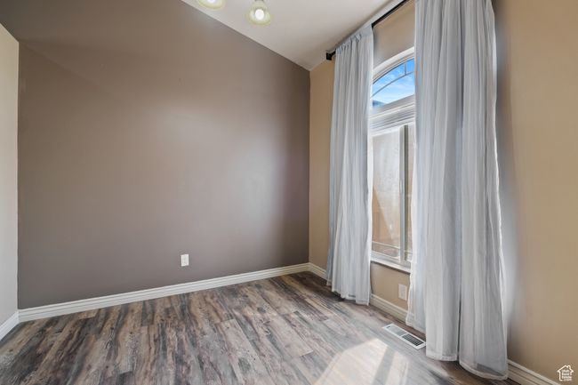 Unfurnished room featuring visible vents, wood finished floors, and baseboards | Image 33