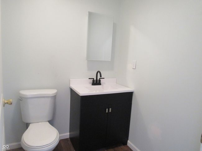 New half bath added with vanity and wood finished floors | Image 13