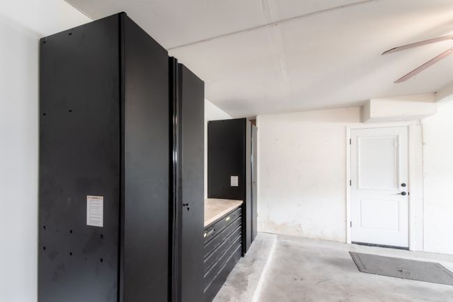 The garage has lockable storage cabinets that convey! Your very own workshop. | Image 38