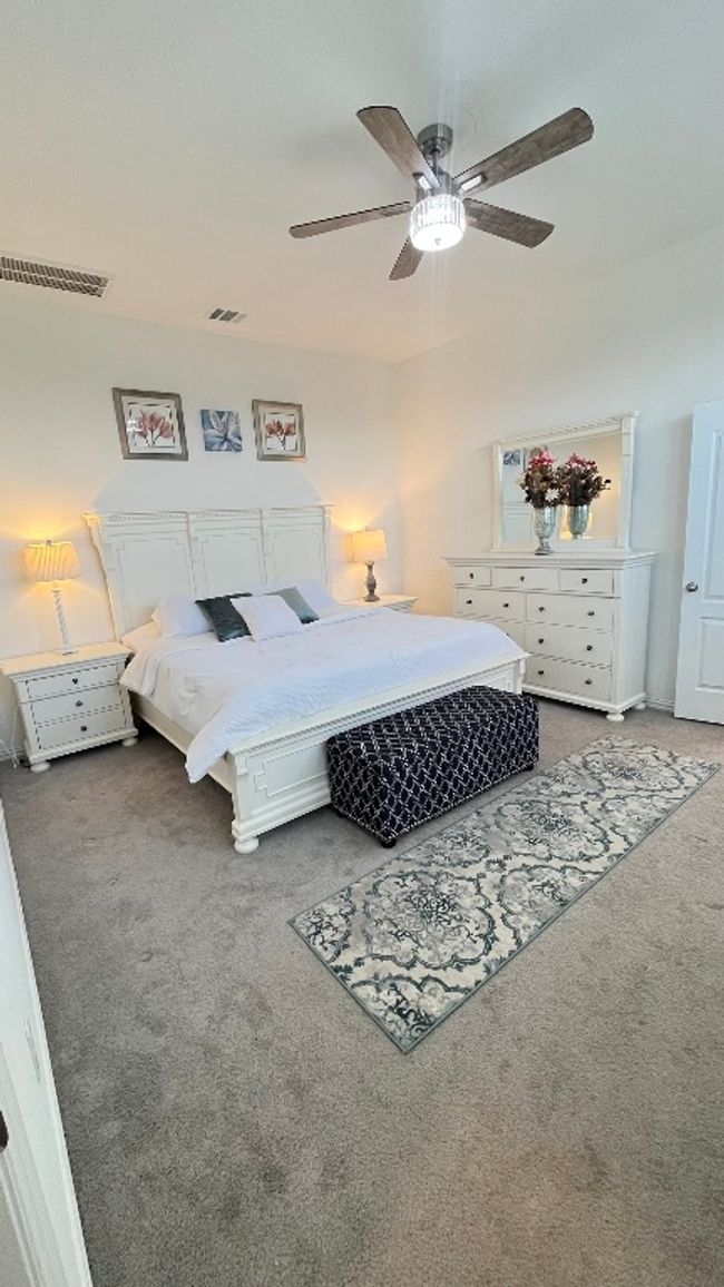 Carpeted bedroom featuring ceiling fan | Image 18