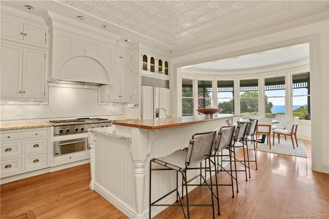 CUSTOM DETAILS // Floor to ceiling custom cabinetry, painted tin ceiling and granite countertops. | Image 10