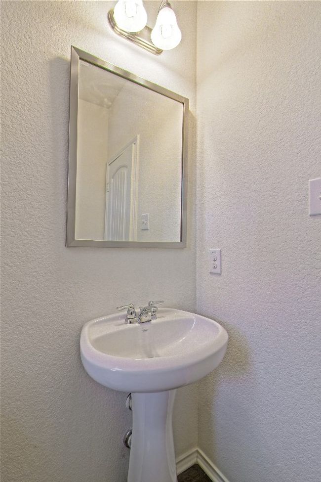 Bathroom featuring a textured wall | Image 7