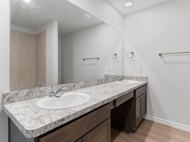 Elegant master bathroom featuring a spacious double-sink vanity. | Image 20
