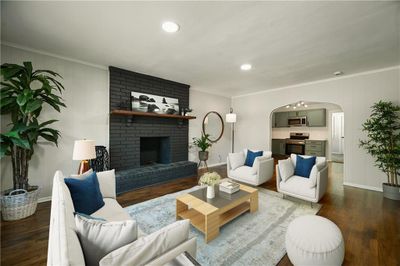 Living room featuring crown molding, a brick fireplace, and dark hardwood / wood-style floors | Image 3