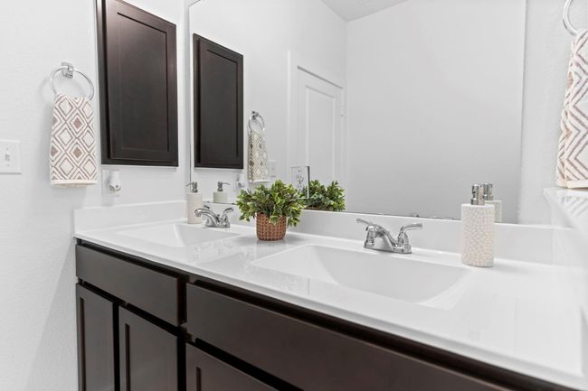 Another view of the primary bath highlights the extended vanity space, under-mounted sinks, and spa-like finishes that elevate everyday routines. **Image Representative of Plan Only and May Vary as Built**. | Image 24