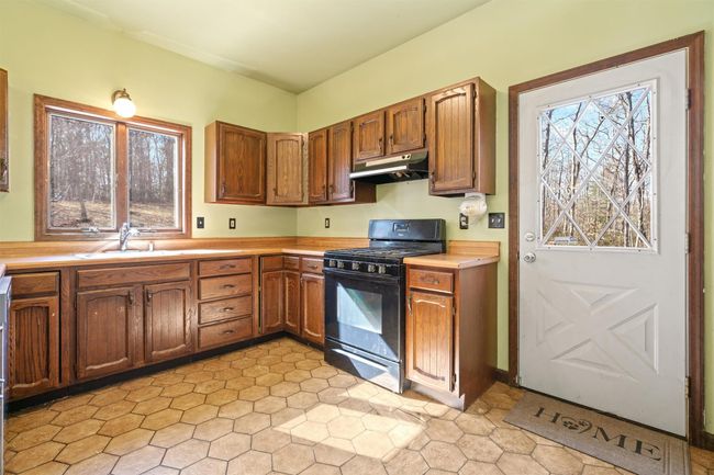 Wood cabinets, pantry, access to side deck, lots of natural light | Image 9