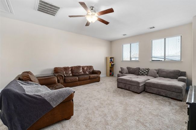 Living room featuring visible vents, carpet, and a ceiling fan | Image 20