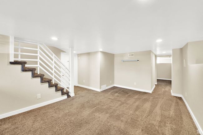 Finished basement with recessed lighting, carpet, visible vents, and baseboards | Image 17
